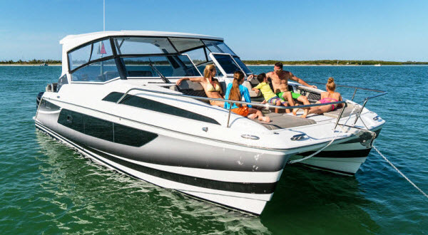 Family relaxing and sunbathing in a boat berthed at the middle of the sea