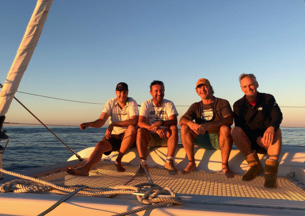 Four men enjoying the ride on a boat