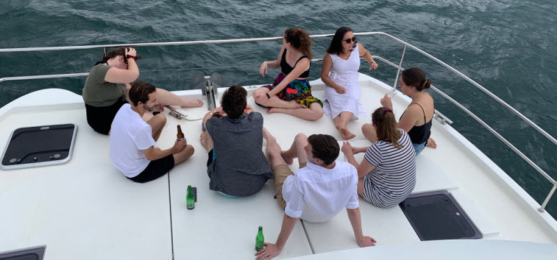 Group of people relaxing while sailing on a yacht