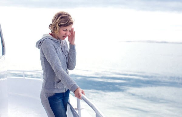 Woman feels dizzy while riding on a boat